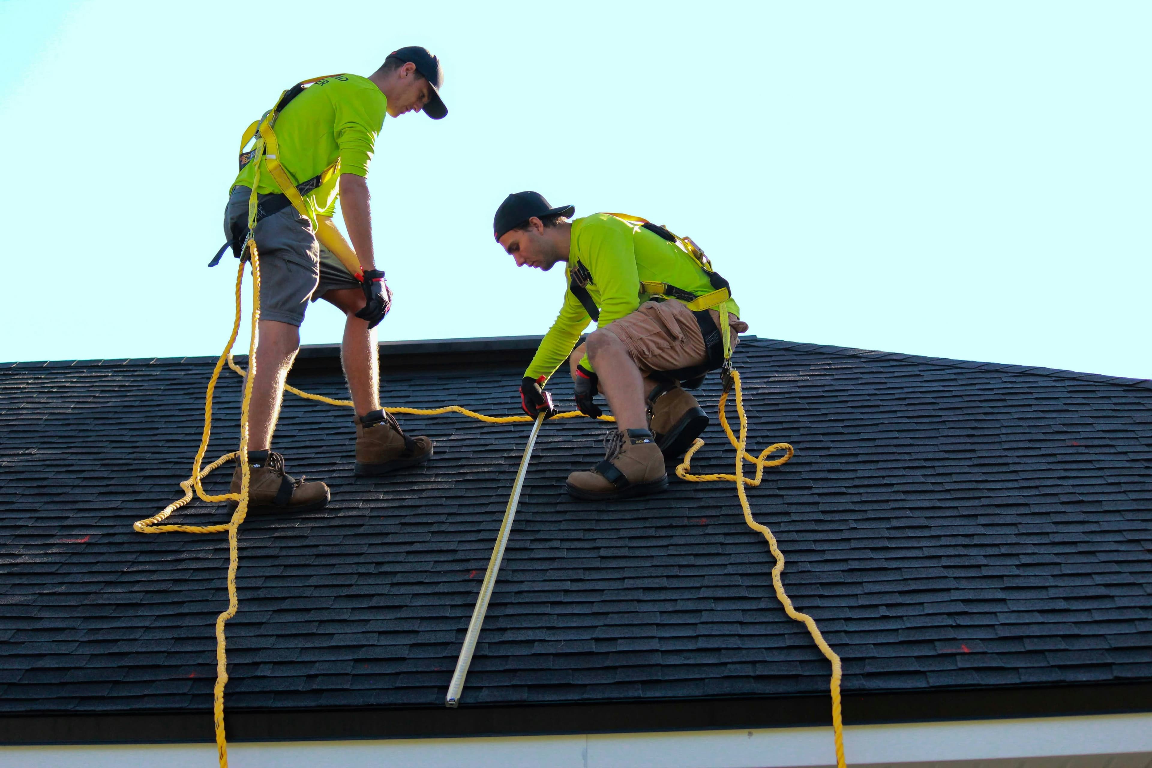 Emergency response crew inspecting a residential roof